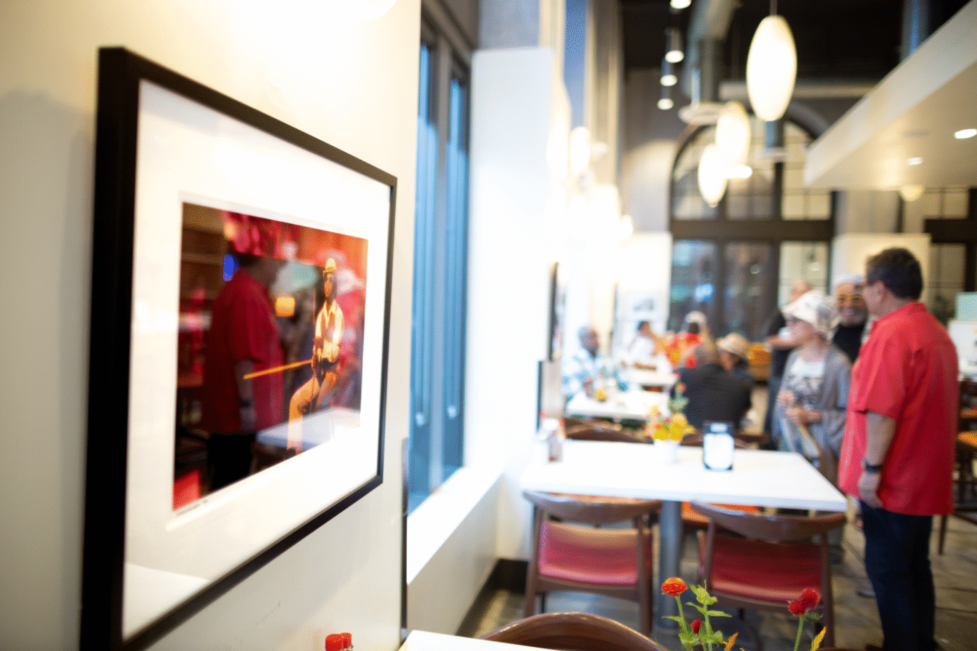 Guests dining and viewing monthly art exhibition at Delicious at The Dunbar